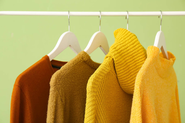 Rack with clothes on color background, closeup - Fotoğraf, Görsel