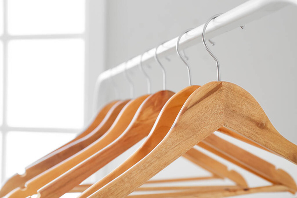 Rack with clothes hangers in room, closeup - Photo, Image