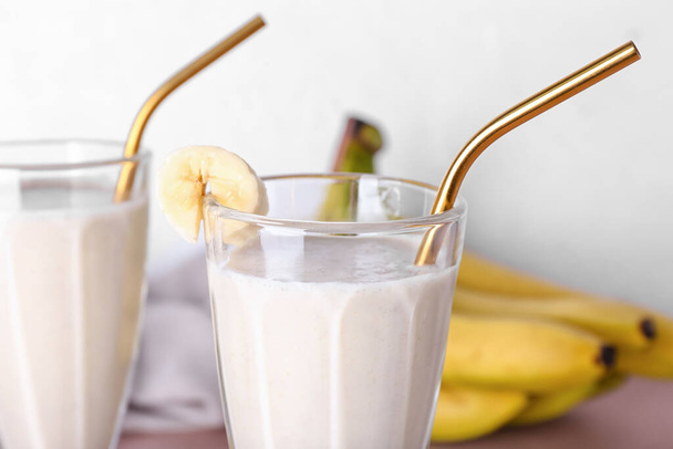 Glass of tasty banana smoothie on table, closeup - Photo, Image