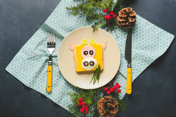 Tasty sandwich in shape of bull on festive table setting - Photo, Image