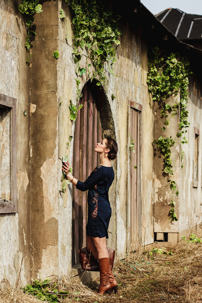 Fashion portrait of beautiful woman on the front of old vintage building - Photo, Image