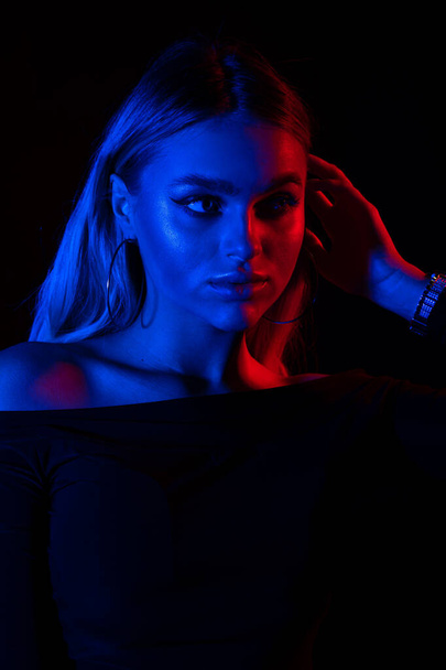 Portrait of fashion young girl in red and blue neon light in the studio - Photo, Image