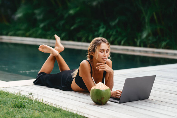 Woman freelance work typing on laptop with fresh coconut . - Foto, imagen
