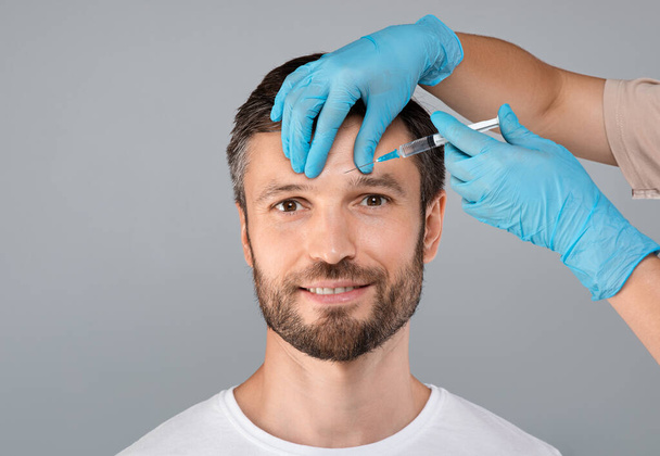 Attractive middle aged man getting brow lift - Fotó, kép