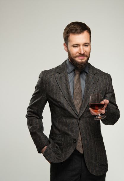 Handsome well-dressed man in jacket with glass of beverage - Fotoğraf, Görsel