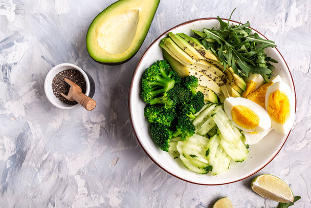 Buddha bowl with avocado, cucumber, arugula, lime and broccoli. vegetarian food concept. Long banner format. space for text. - Photo, Image