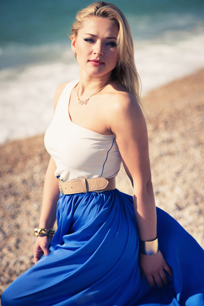 young beautiful woman blonde poses on a beach - Fotó, kép