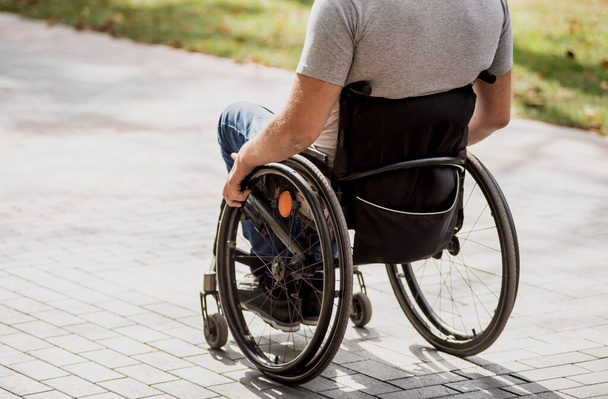 Handicapped man in wheelchair walk at the park alley - Foto, Imagen