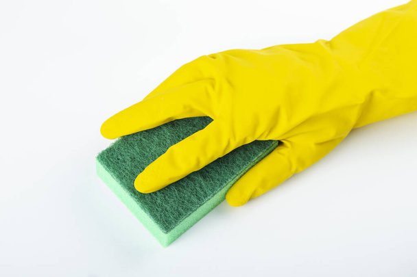 Sponge for washing dishes in hand. Hand in a latex glove isolated on white. Hand gesture or sign isolated on white. Cleanliness and cleaning concept. File contains clipping path. - Fotó, kép