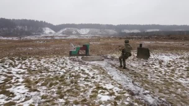 A soldier runs into a firing position and fires a burst of tracer rifle. - Footage, Video