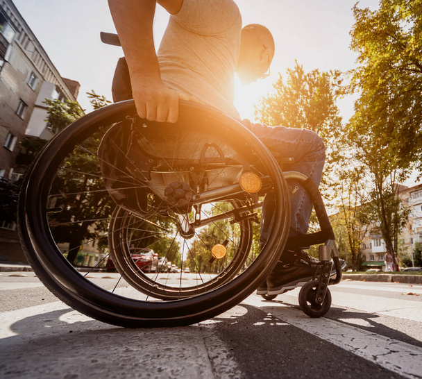 Handicapped man in wheelchair crossing street road - Fotografie, Obrázek