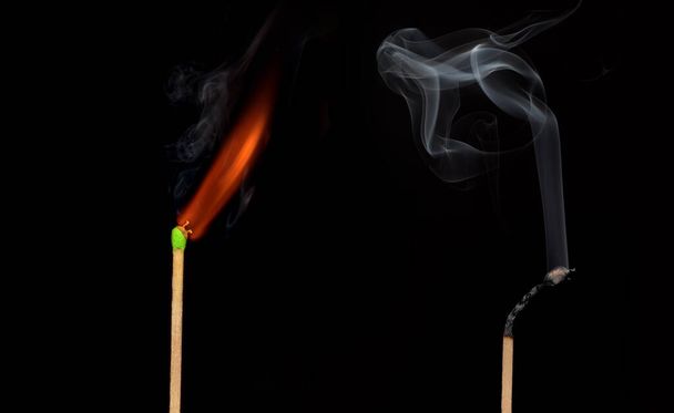 Ignition of match with smoke, isolated on black background - Photo, Image