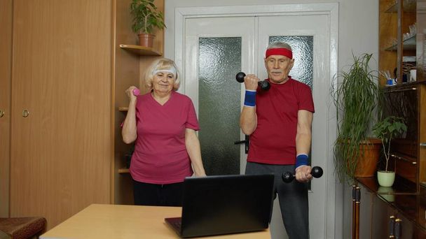 Senior elderly couple grandmother grandfather doing workout with dumbbells, fitness exercising - Photo, Image