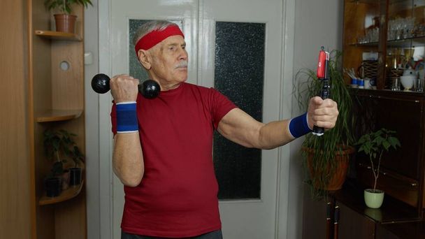 Gepensioneerde senior man doet workout, training, fitness, sport-oefeningen tijdens het coronavirus - Foto, afbeelding