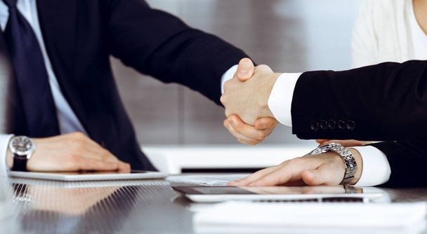 Business people shaking hands after contract signing in modern office. Teamwork and handshake concept - Zdjęcie, obraz