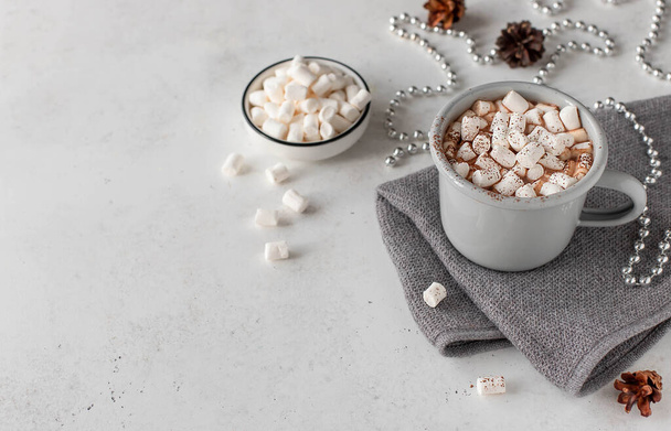 hot chocolate milk with marshmallows and holiday decoration on a light background. Holiday concept with copy space. - Fotó, kép