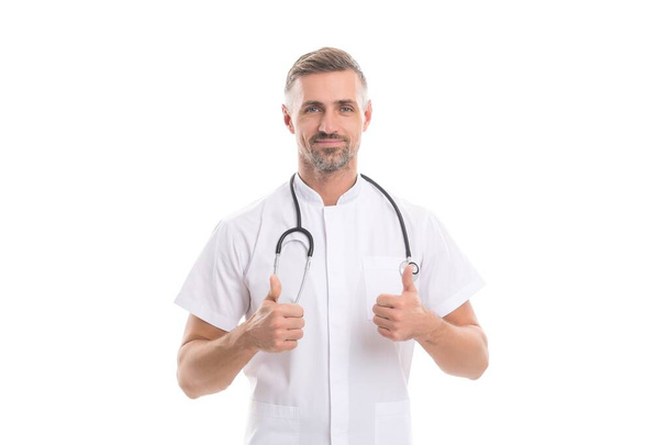 physician man with stethoscope medicine tool isolated on white do patient reception during coronavirus pandemic show thumb up gesture, successful treatment - Valokuva, kuva