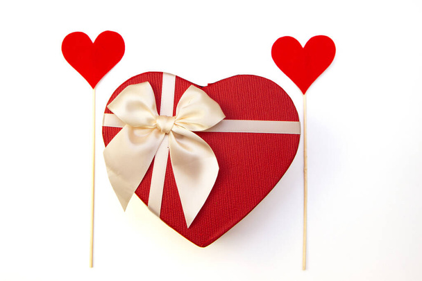 Valentines day congratulation concept. Heart shape gift box with bow and paper hearts - Fotó, kép