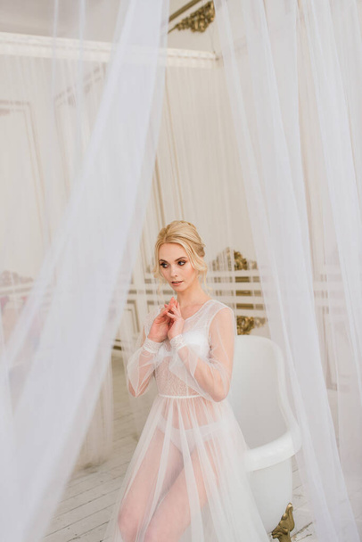 Conceptual wedding, the morning of the bride in the European style. Boudoir dress, fees in the interior Studio. White minimalism for bride - Photo, Image