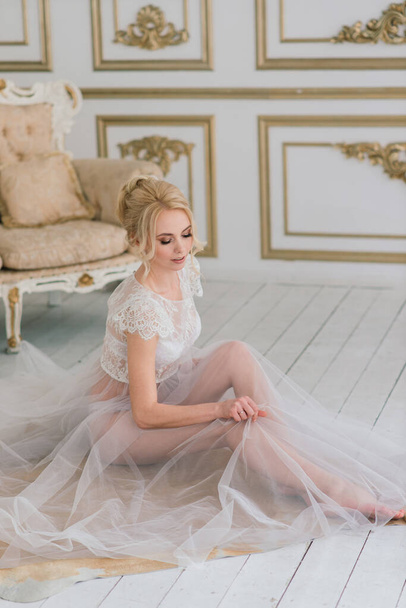 Conceptual wedding, the morning of the bride in the European style. Boudoir dress, fees in the interior Studio. White minimalism for bride - Фото, зображення