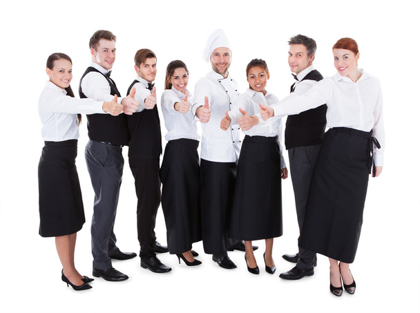 Waiters and waitresses showing thumbs up sign - Фото, изображение