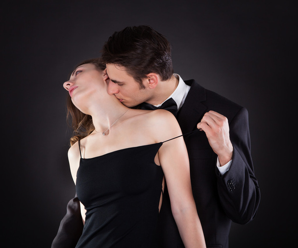 Man Kissing Woman On Neck While Removing Dress Strap - Fotoğraf, Görsel