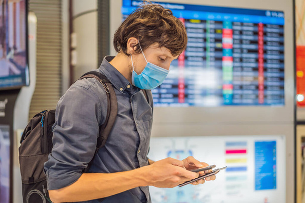 Man traveler with medical face mask to protection the coronavirus in airport - Photo, Image