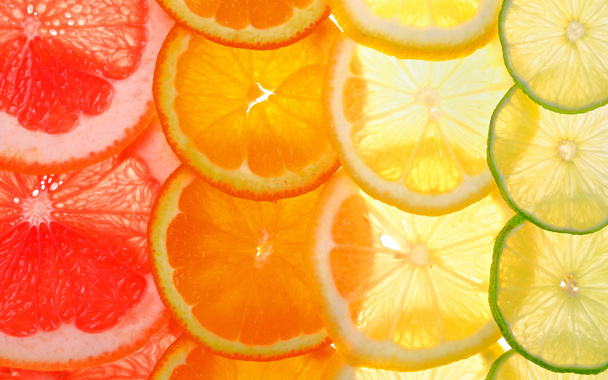 Sliced citrus fruits background  - Zdjęcie, obraz