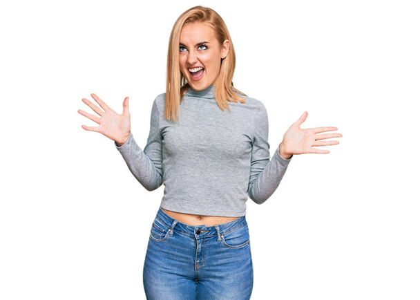 Beautiful caucasian woman wearing casual clothes crazy and mad shouting and yelling with aggressive expression and arms raised. frustration concept.  - Photo, image