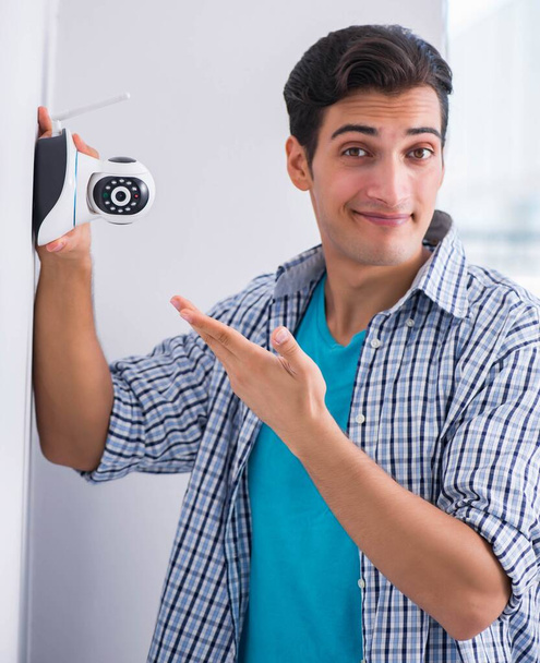Man installing surveillance CCTV cameras at home - Fotoğraf, Görsel