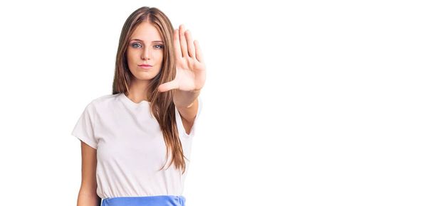 Young beautiful blonde woman wearing summer style doing stop sing with palm of the hand. warning expression with negative and serious gesture on the face.  - Photo, Image