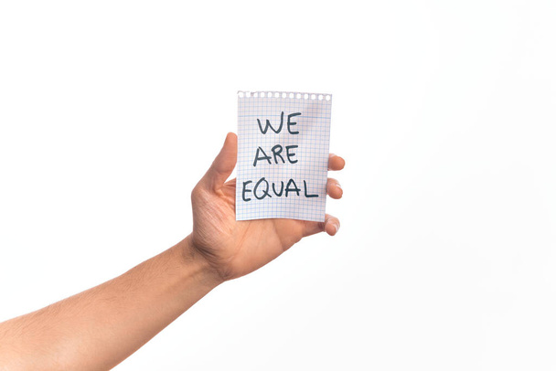 Cardboard banner WE ARE EQUAL, protesting for equal rights over isolated white background - Photo, Image