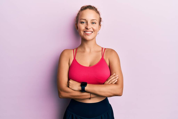 Beautiful caucasian woman wearing sportswear happy face smiling with crossed arms looking at the camera. positive person.  - Photo, Image