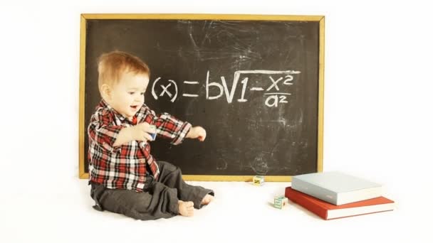 baby boy in front of a blackboard - Footage, Video