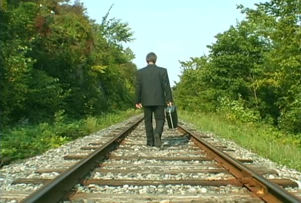 鉄道線路の上を歩いてビジネス男 - 映像、動画