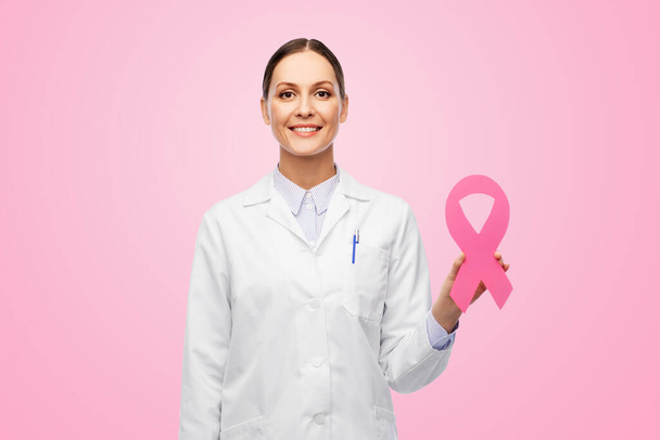 female doctor with breast cancer awareness ribbon - Fotoğraf, Görsel