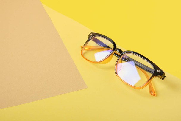 glasses on beige and yellow background, geometric background, trend colors, illumination yellow geometric background copy space - 写真・画像