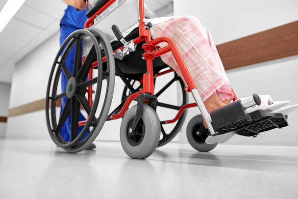 nurse with senior patient in wheelchair at clinic - Valokuva, kuva