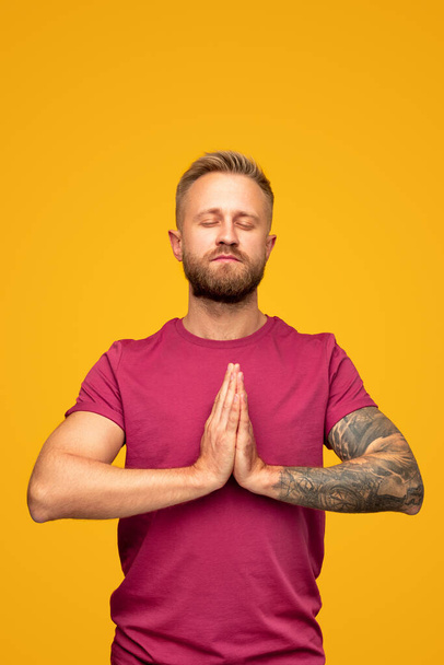 Calm modern guy meditating for stress relief - Foto, Imagen