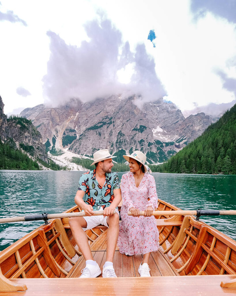 Beautiful lake in the italian alps, Lago di Braies, couple on vacation in the Italian Alps Italy - Photo, Image