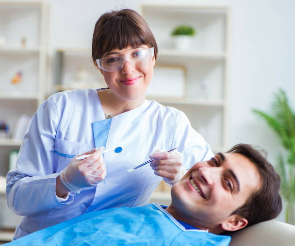 Жінка-стоматолог лікар з пацієнтом чоловічої статі в лікарні
 - Фото, зображення