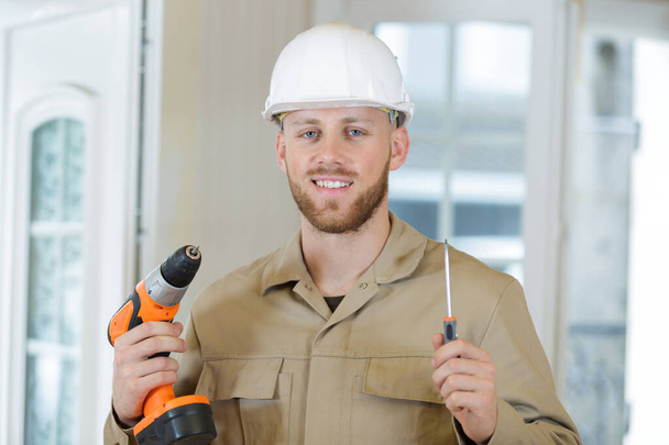 portrait of a happy male builder in with helmet - Foto, Imagem