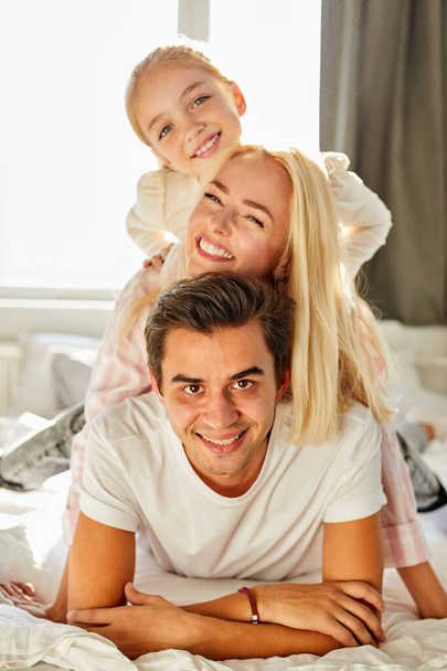 portrait of happy family on bed - Photo, image