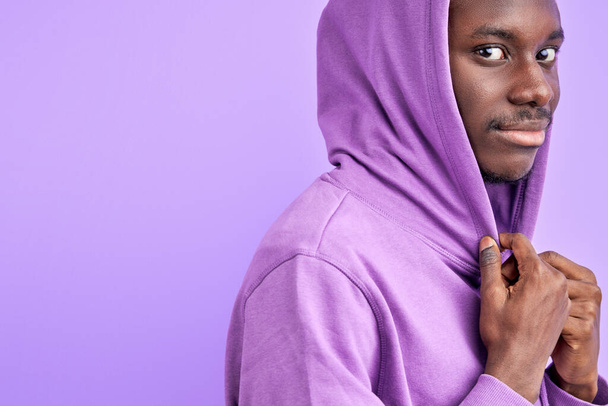 stylish dark skinned male model in pullover looks at camera - Photo, image