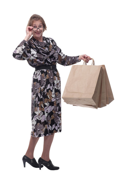 Senior woman addicted to shopping, holding up a handful of bags. - Фото, изображение
