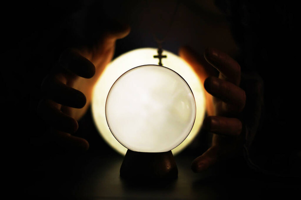 Crystal Ball on the floor with bokeh. Glass ball with colorful bokeh light, new year celebration concept. - Photo, Image