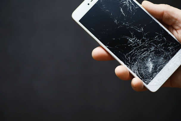 Smartphone with a broken touch screen. Mobile phone broken. The phone crashed. Replacing broken glass on a cell phone. Smartphone repair. - Photo, Image