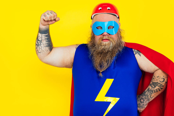 Funny man wearing a superhero costume - Фото, изображение