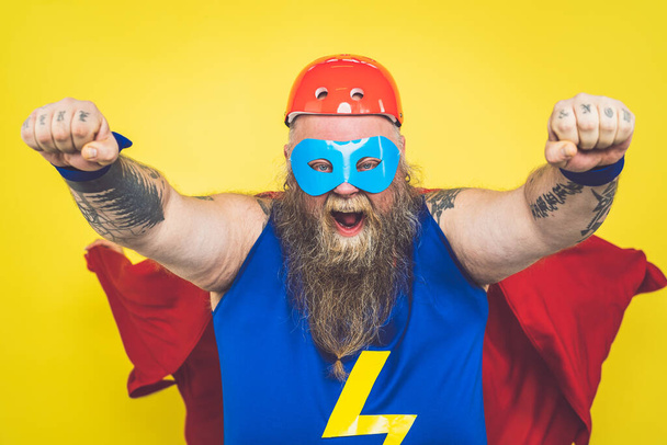Funny man wearing a superhero costume - Foto, afbeelding