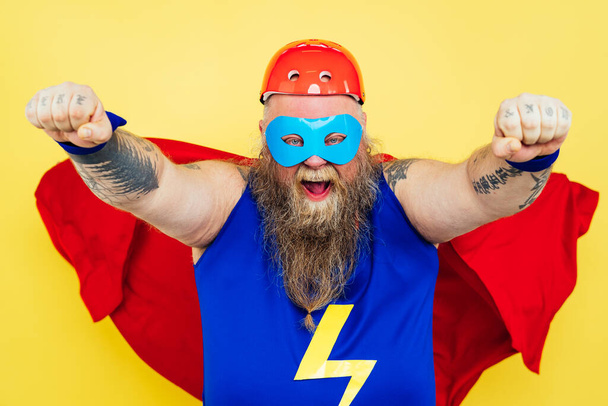 Funny man wearing a superhero costume - Foto, Bild